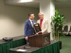 two people with an award