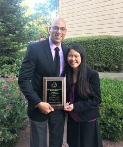 Two people with an award