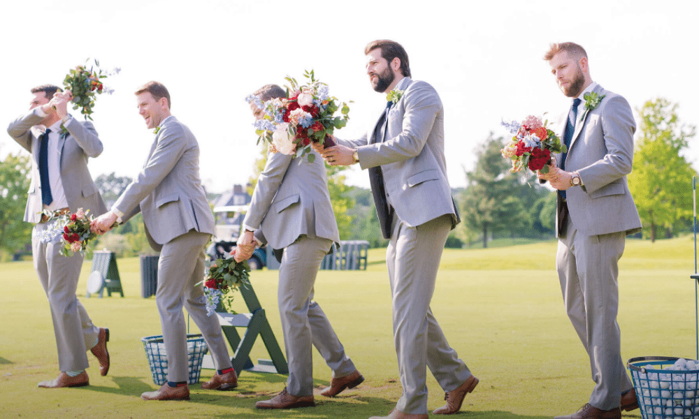 wedding photo of groomsmen golfing with flowers at New Albany Country Club
