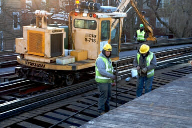 A pair of CTA workers repair “L” tracks