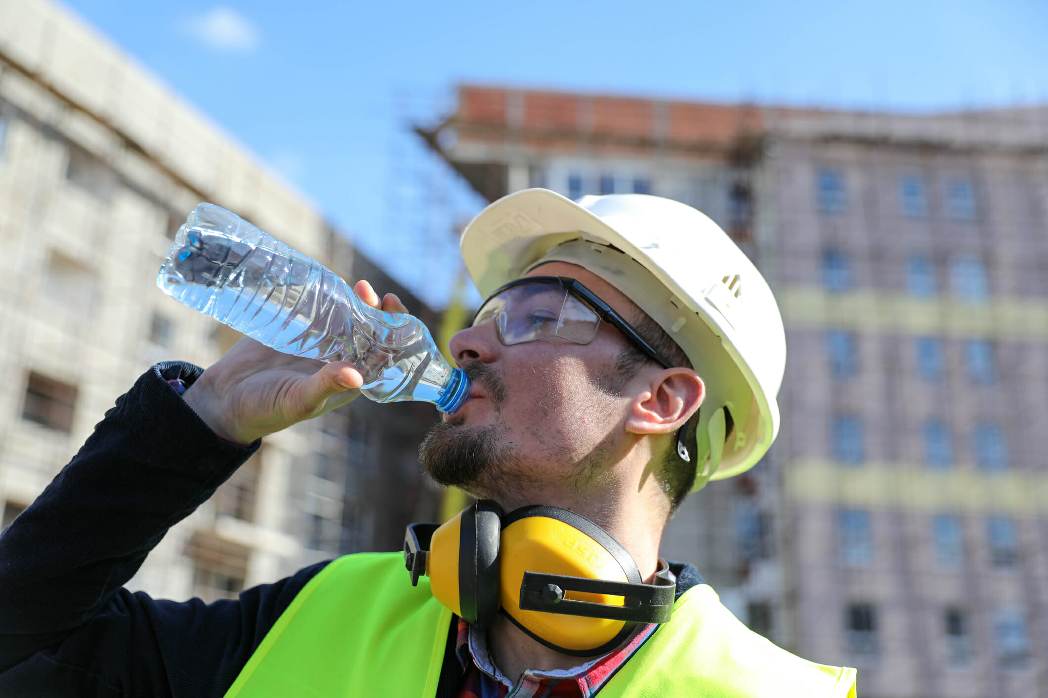 boss at construction site with bottle of water, close up