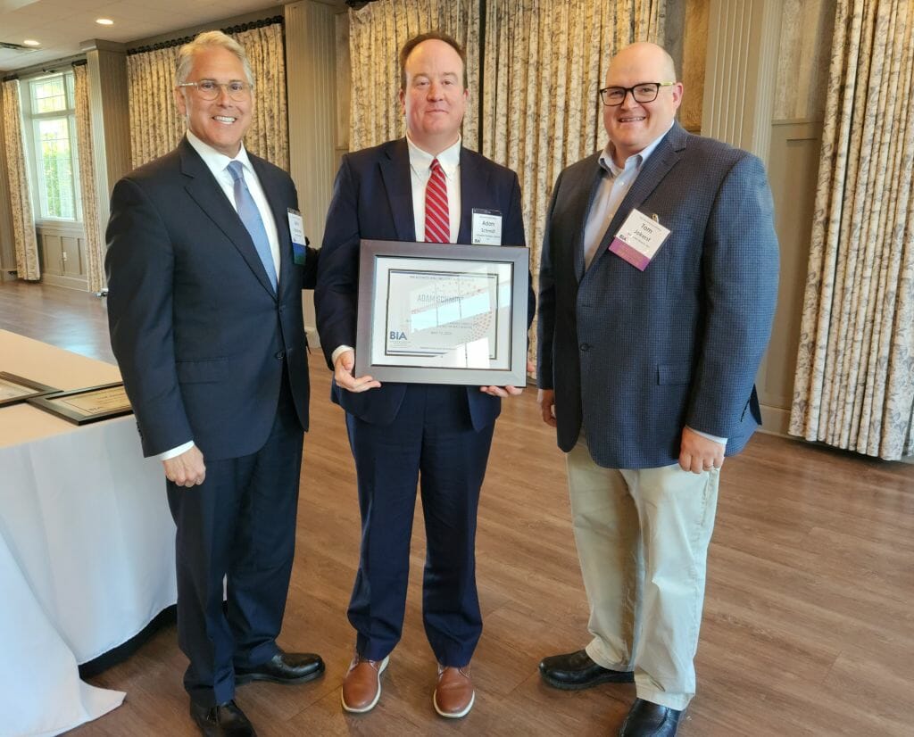 Adam Schmidt, vice president of J. Grimbilas Strategic Solutions, receives the Business &amp; Industry Association’s Above and Beyond Award at BIA’s Annual Business Meeting at LaBelle Winery in Derry Wednesday, May 17. New BIA Chair John Kacavas, left, and outgoing Chair Tom Jokerst, right, present the award. (Courtesy photo)