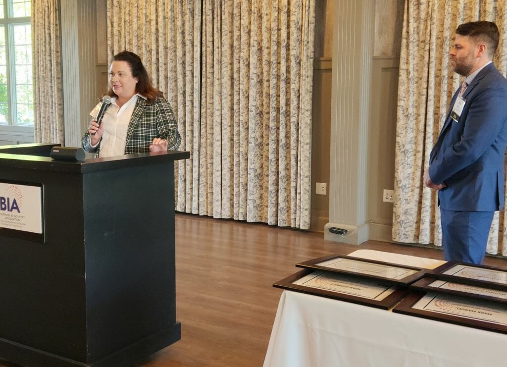 Caitlin McCormick, vice president of sales and account management at United Healthcare in New Hampshire, delivers sponsor remarks during BIA’s Annual Business Meeting at LaBelle Winery in Derry Wednesday, May 17. BIA President and CEO Michael Skelton is at right. (Courtesy photo)
