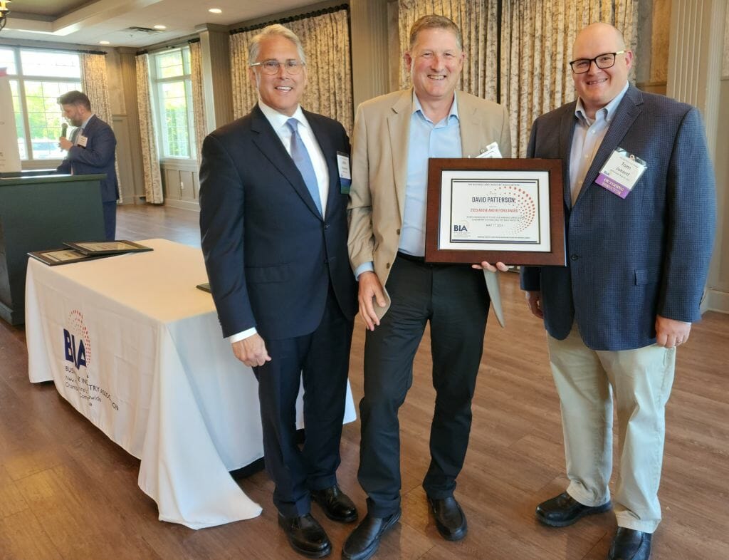 Dave Patterson, BIA board member and a manufacturing, operations, and supply chain industry executive, receives the Business &amp; Industry Association’s Above and Beyond Award at BIA’s Annual Business Meeting at LaBelle Winery in Derry Wednesday, May 17. New BIA Chair John Kacavas, left, and outgoing Chair Tom Jokerst, right, present the award. (Courtesy photo)