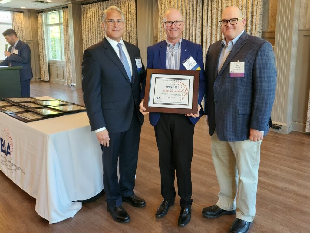 James Dean, president of the University of New Hampshire, receives the Business &amp; Industry Association’s Above and Beyond Award at BIA’s Annual Business Meeting at LaBelle Winery in Derry Wednesday, May 17. New BIA Chair John Kacavas, left, and outgoing Chair Tom Jokerst present the award. (Courtesy photo)