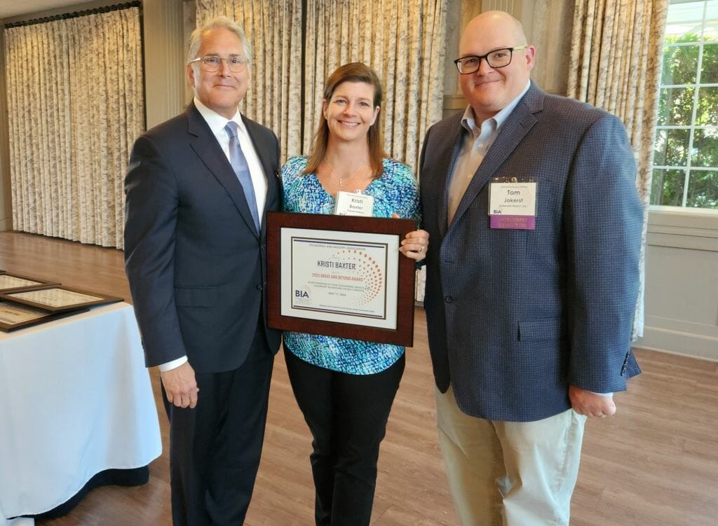 Kristi Baxter, executive coach with Sojourn Partners, receives the Business &amp; Industry Association’s Above and Beyond Award at BIA’s Annual Business Meeting at LaBelle Winery in Derry Wednesday, May 17. New BIA Chair John Kacavas, left, and outgoing Chair Tom Jokerst present the award. (Courtesy photo)