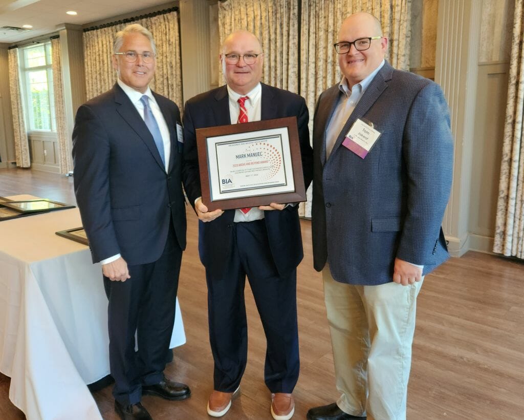 Mark Manuel, cofounder of Industrial Marketing, receives the Business &amp; Industry Association’s Above and Beyond Award at BIA’s Annual Business Meeting at LaBelle Winery in Derry Wednesday, May 17. New BIA Chair John Kacavas, left, and outgoing Chair Tom Jokerst, right, present the award. (Courtesy photo)