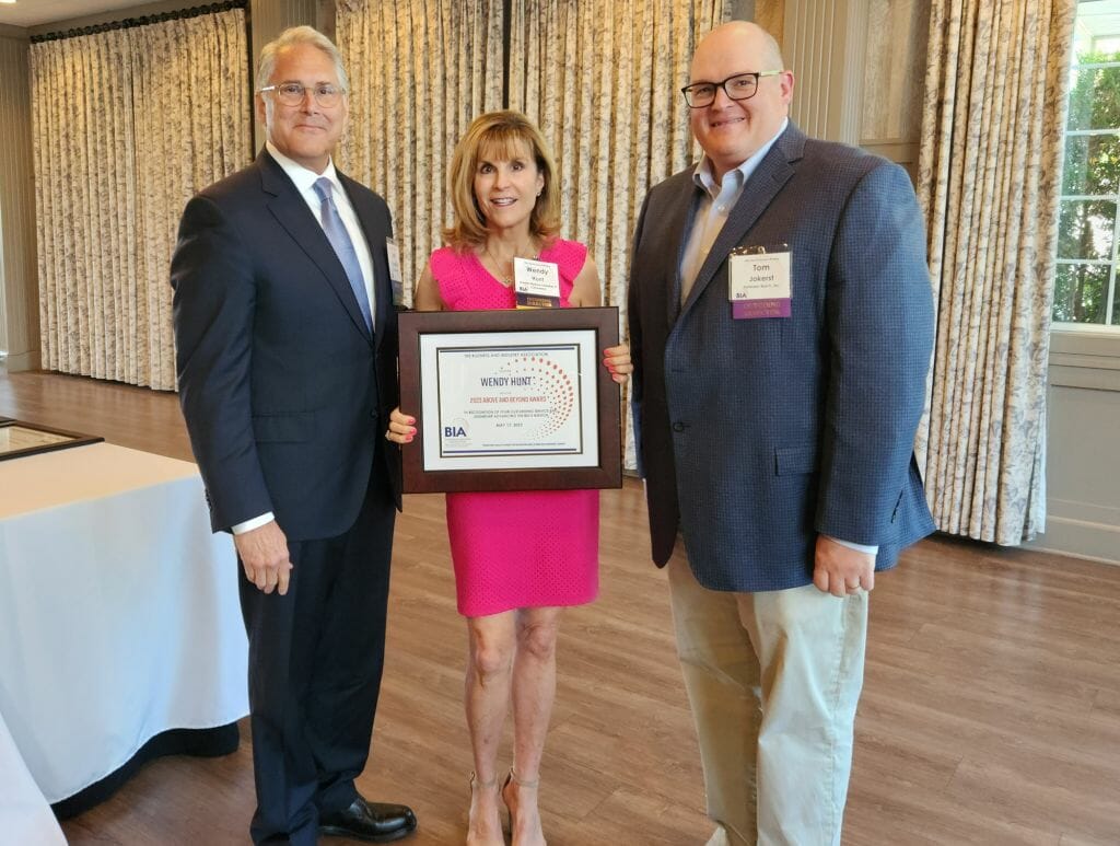Wendy Hunt, president and CEO of the Greater Nashua Chamber of Commerce, receives the Business &amp; Industry Association’s Above and Beyond Award at BIA’s Annual Business Meeting at LaBelle Winery in Derry Wednesday, May 17. New BIA Chair John Kacavas, left, and outgoing Chair Tom Jokerst, right, present the award. Hunt was also reelected to BIA’s Board of Directors as a representative of the N.H. Association of Chamber of Commerce Executives. (Courtesy photo)