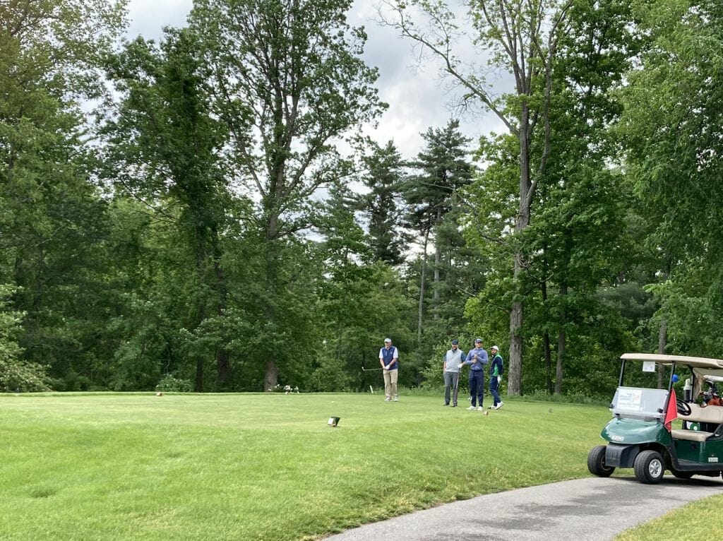 BIA President and CEO Michael Skelton, second from left, and his team waits to tee off in the scramble format of BIA’s 28th annual Golf Classic, presented by Comcast.