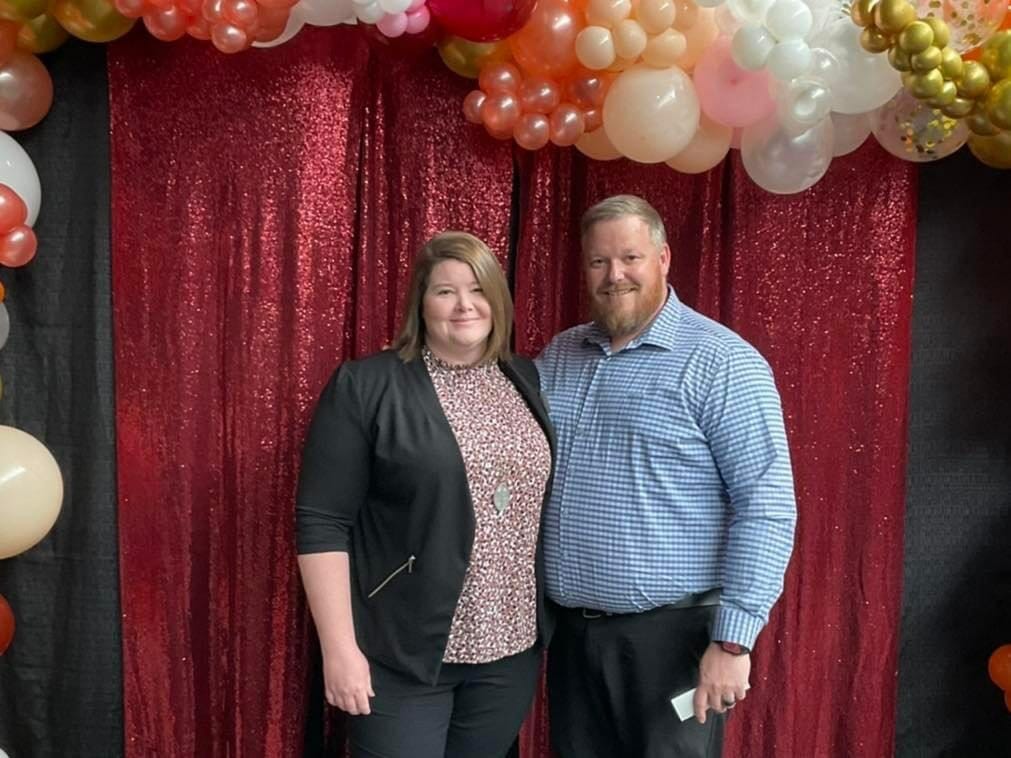 2 people at the photo backdrop at business after hours