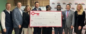 YWCA and Key Bank representatives pose with a large check