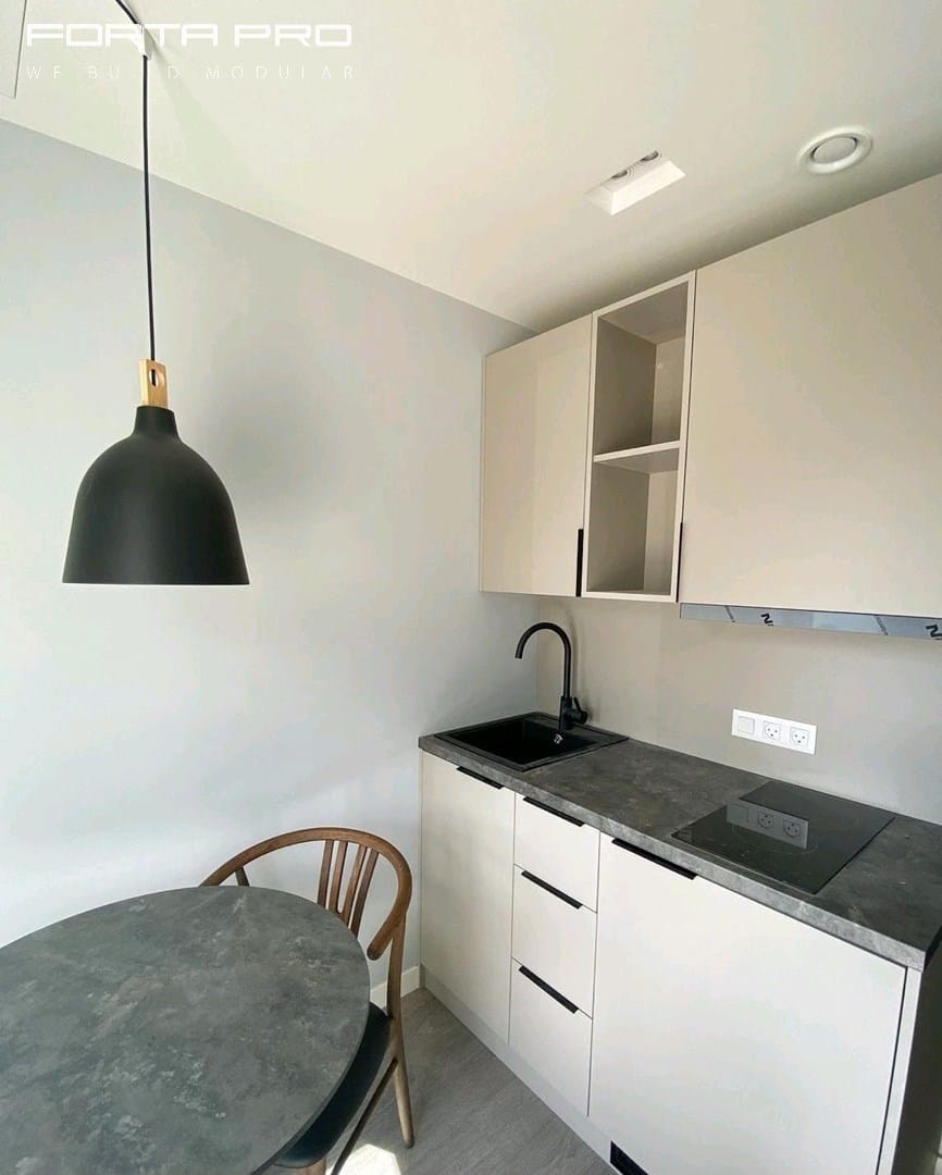 interior of hage's featuring a sink, cabinets with open shelving, and a chandelier