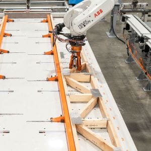 A robot programmed by House of Design assembles a truss for a modular building
