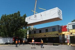 crane lowering modular building into place