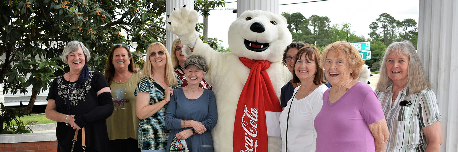people smiling with bear mascot