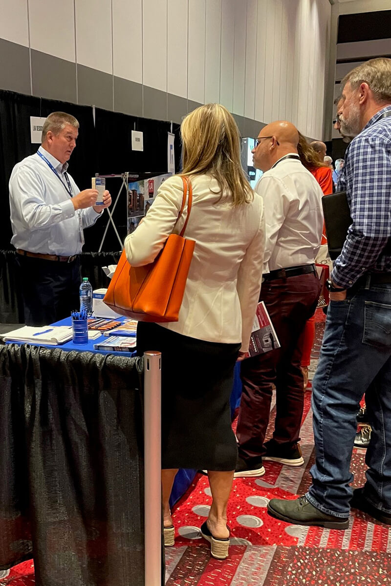 Exhibtor Johns Manville converses with attendees prior to the start of the day's presentations.