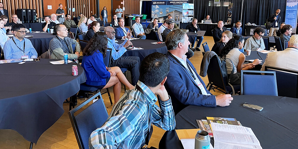 An Offsite Construction Summit attendee asks a question during a breakout session Q&amp;A.