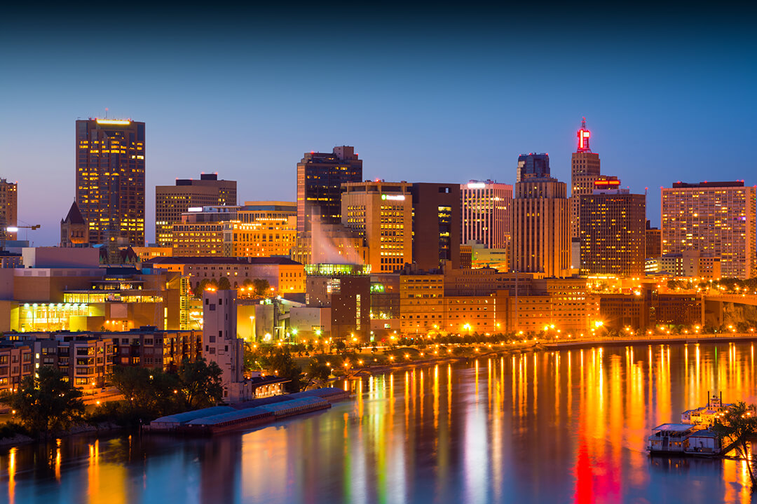 Downtown Saint Paul skyline at dusk / sunset with the Mississippi River in the foreground.  Saint Paul is part of the Minneapolis-Saint Paul Twin Cities area.