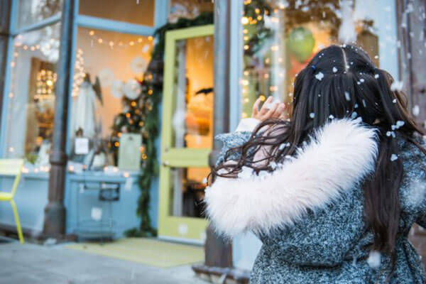 Girl outside store in snow