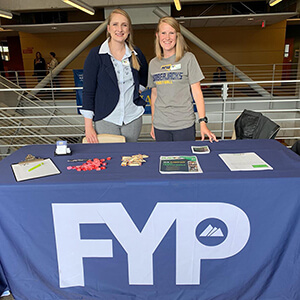 Two FYP young professionals at booth