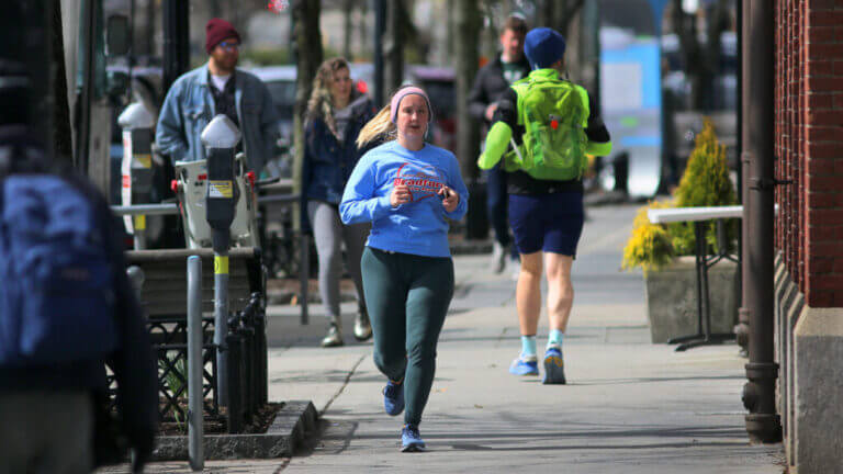 Brookline, MA - 03/24/20 -  Despite the COVID-19 coronavirus crisis, people were out strolling and jogging on Beacon Street in Coolidge Corner.  (Lane Turner/Globe Staff) Reporter:  ()  Topic: ()