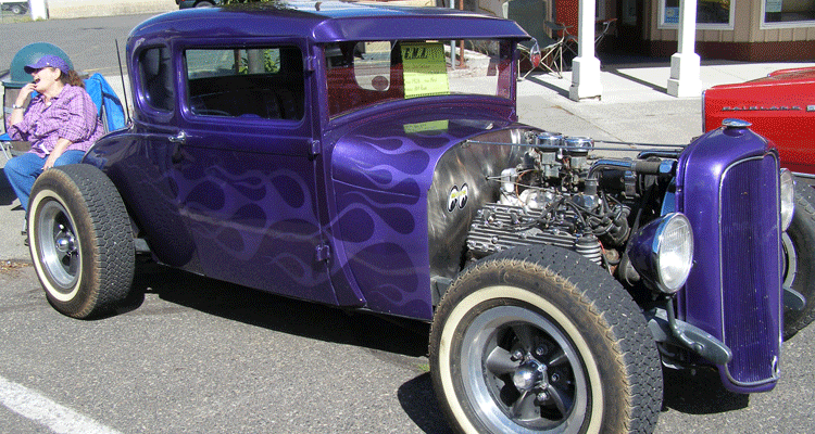 classic funny car with exposed engine and flames on the sides