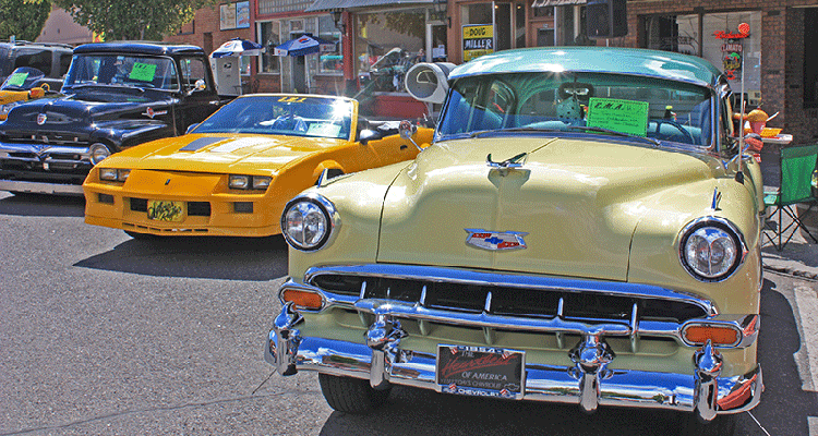 classic cars on display on city street