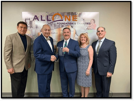 LBA President Michael Cosgrove, Esq. presents the 2022 Community Service Award to AllOne Foundation and Charities. 