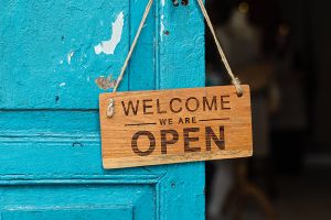 "Welcome we are open" sign