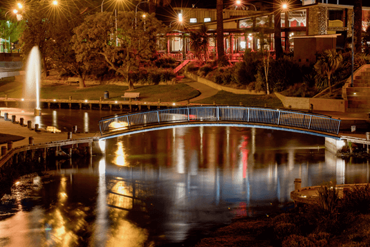 walking bridge over a stream at night