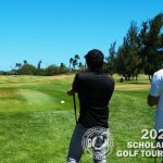 Teammates watch as a player tees off