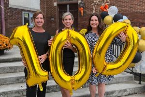 women holding 100