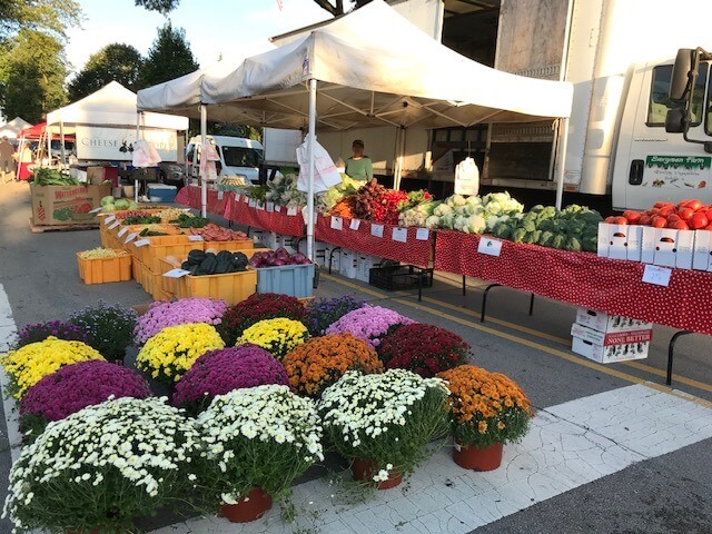 flowers and vegetables in a farmers market