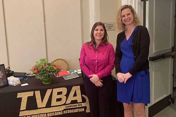 two women in front of tvba booth