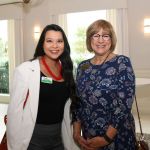 2 women at an event smiling