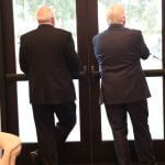 2 men in front of a door