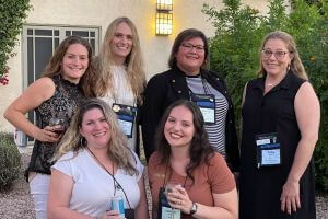 scottsdale-1 Group of six women in two rows smiling at camera.