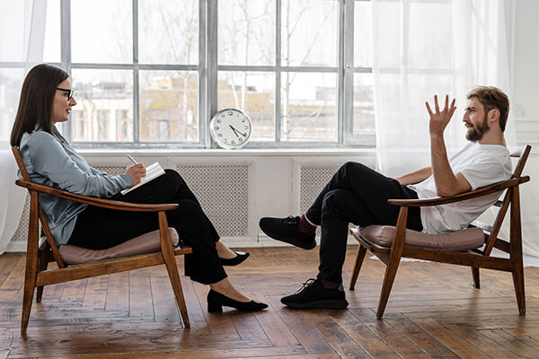 mental-health man talking to a therapist