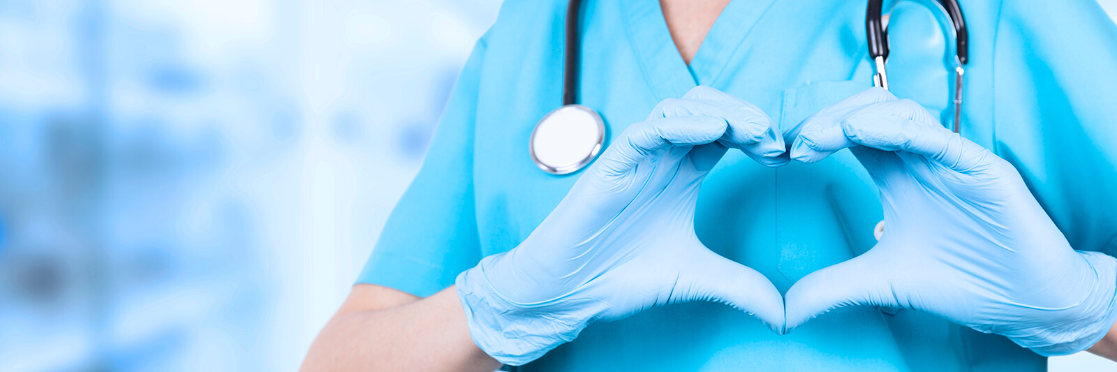 Doctor woman, hands in medical blue gloves, making a heart shape.