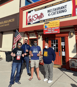 4 men outside chef shells restaurant