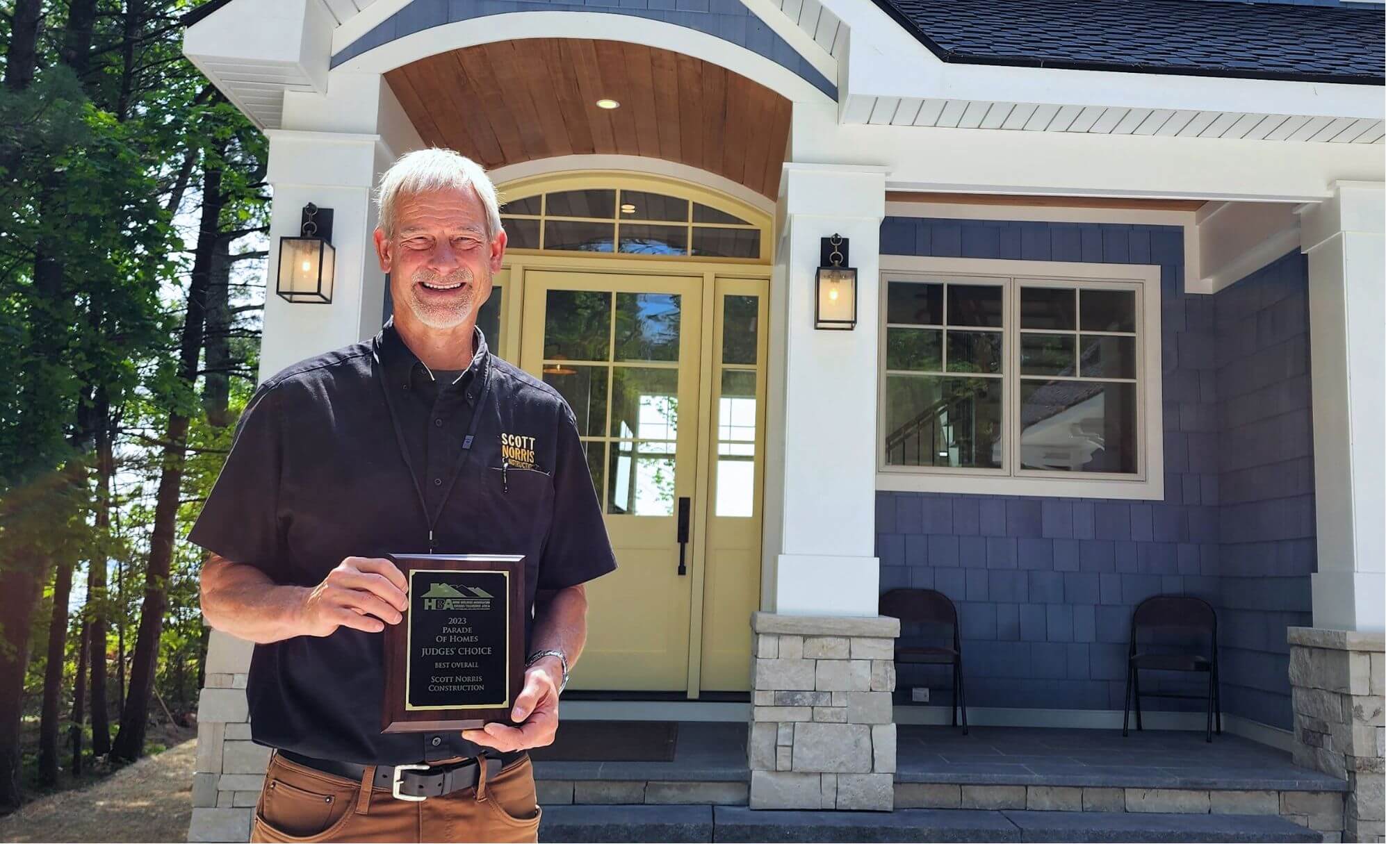 Scott Norris Holds an award for the 2023 Parade of Homes