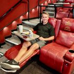 man reclined in theater chair
