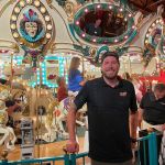 man in front or carousel at event