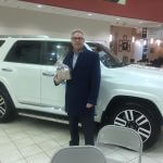 man in front of Toyota vehicle