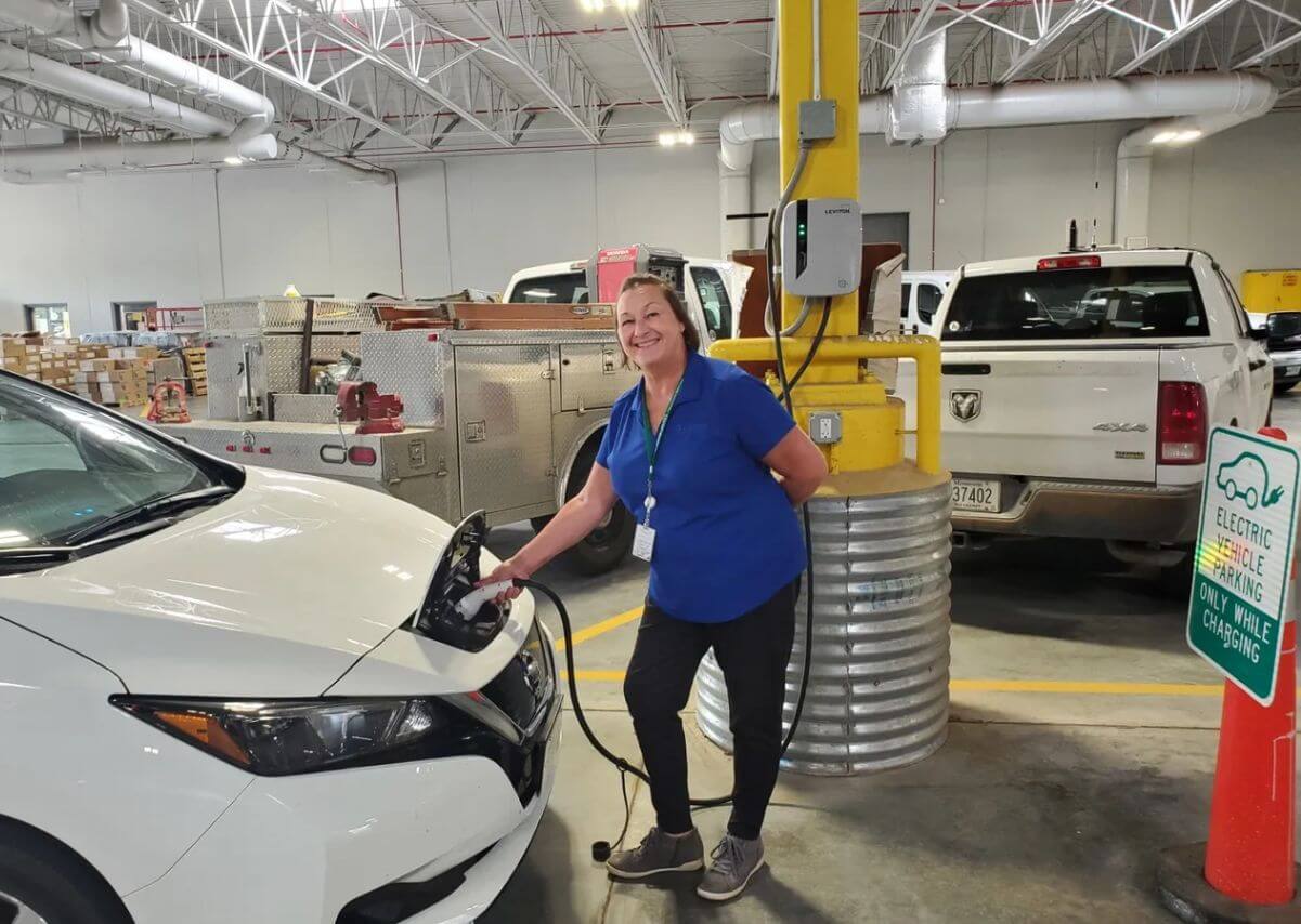 woman charging electric car