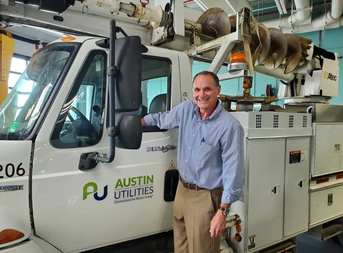 man in front of austin utilities truck