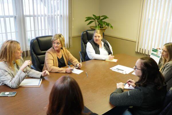 sitting around a table having a meeting