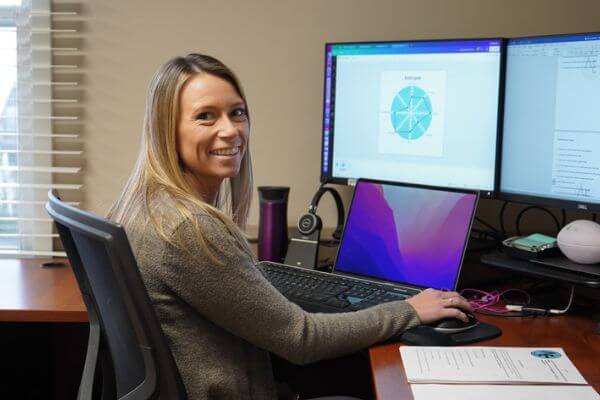 woman sitting at her computer smiling