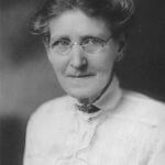 historic photo of woman in glasses