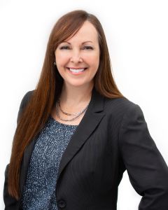 Brooke Nunn Headshot of a woman in a black blazer and blouse